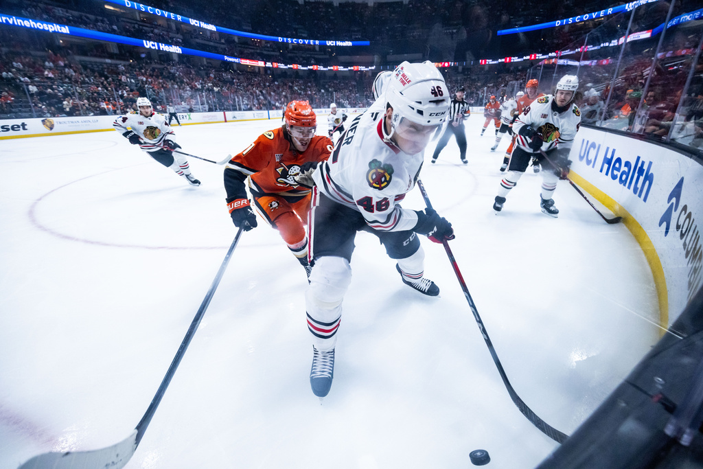 Chicago Blackhawks defenseman Louis Crevier (46) defends the puck against the Anaheim Ducks during the first period of an NHL hockey game Sunday, Dec. 7, 2025, in Anaheim, Calif. (AP Photo/Ethan Swope)