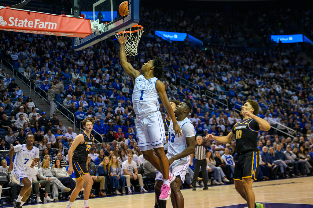 BYU guard Robert Wright III (1) lays the ball into the basket during the first half of an NCAA college basketball game against UC Riverside, Saturday, Dec. 13, 2025, in Provo, Utah. (AP Photo/Tyler Tate)