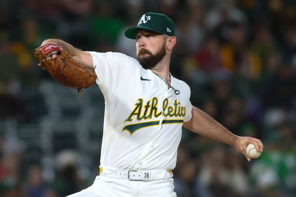 Athletics pitcher Hogan Harris throws to a Texas Rangers batter during the sixth inning of a baseball game Wednesday, April 15, 2026, in West Sacramento, Calif. (AP Photo/Scott Marshall)