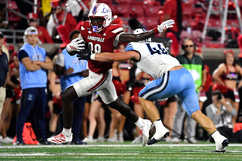 Louisville tight end Jaleel Skinner is wrapped up by Villanova linebacker Walker Murray (44) during the first half of an NCAA college football game in Louisville, Ky., Friday, Sept. 11, 2026. (AP Photo/Timothy D. Easley)