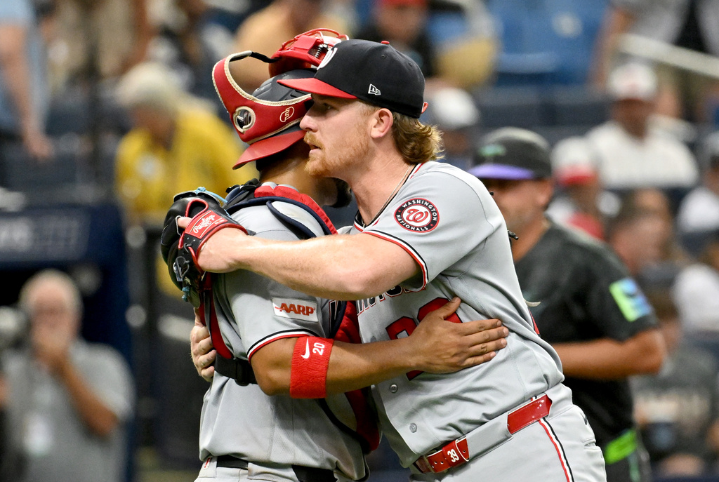 Washington Nationals catcher Keibert Ruiz, left, and pitcher Clayton Beeter, right, celebrate after their win over the Tampa Bay Rays in a baseball game Saturday, June 20, 2026, in St. Petersburg, Fla. (AP Photo/Jason Behnken)
