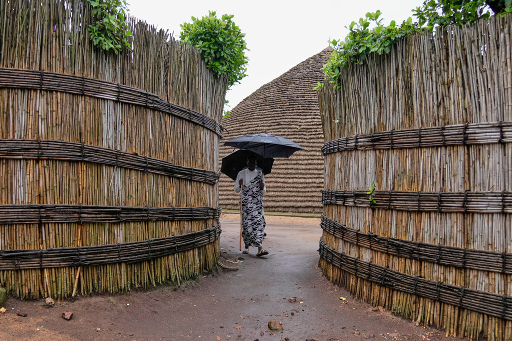 A herdsman walks around the compound of the King's Palace Museum in Nyanza, Rwanda, Saturday, March 21, 2026. (AP Photo/Brian Inganga)
