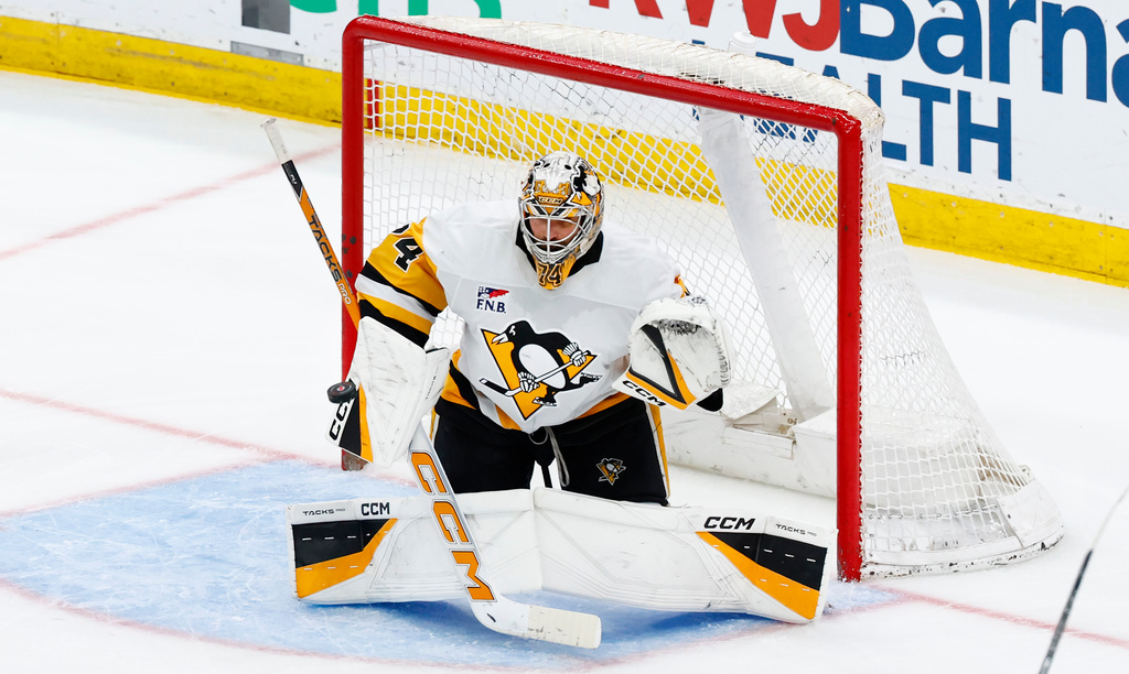 Pittsburgh Penguins goaltender Stuart Skinner makes a save against the New Jersey Devils during the third period of an NHL hockey game, Thursday, April 9, 2026, in Newark, N.J. (AP Photo/Noah K. Murray)