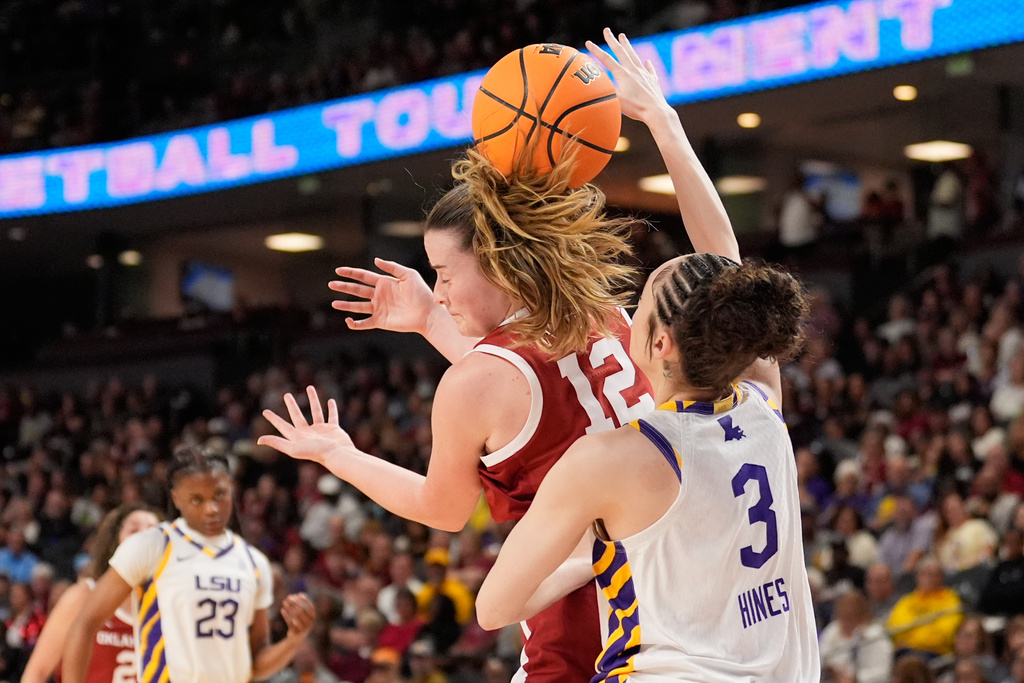 LSU guard Bella Hines vies for the ball with Oklahoma guard Payton Verhulst during first half of an NCAA college basketball game in the quarterfinals of the Southeastern Conference tournament, Friday, March 6, 2026, in Greenville, S.C. (AP Photo/Chris Carlson)