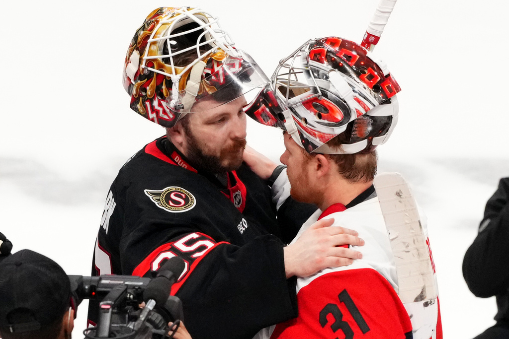 Ottawa Senators goaltender Linus Ullmark (35) embraces Carolina Hurricanes goaltender Frederik Andersen (31) after Game 4 of a first-round NHL Stanley Cup playoff hockey series, Saturday, April 25, 2026, in Ottawa, Ontario. (Sean Kilpatrick/The Canadian Press via AP)