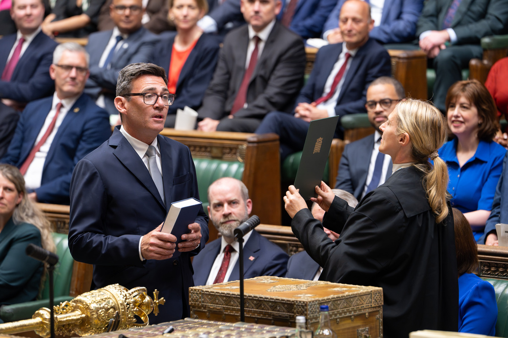 Andy Burnham, front left, is sworn-in as an MP in the House of Common in London, England, Monday, June 22, 2026. (House of Commons via AP)