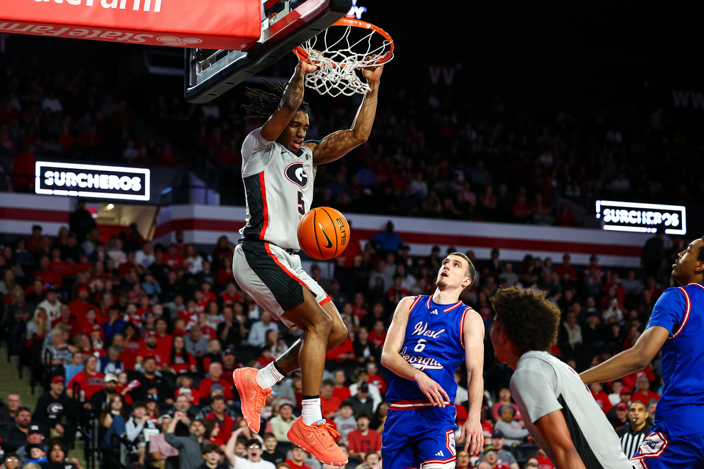 Georgia guard Jeremiah Wilkinson (5) dunks against West Georgia guard Matija Žužic (6) during the second half of an NCAA college basketball game, Monday, Dec. 22, 2025, in Athens, Ga. (AP Photo/Colin Hubbard)