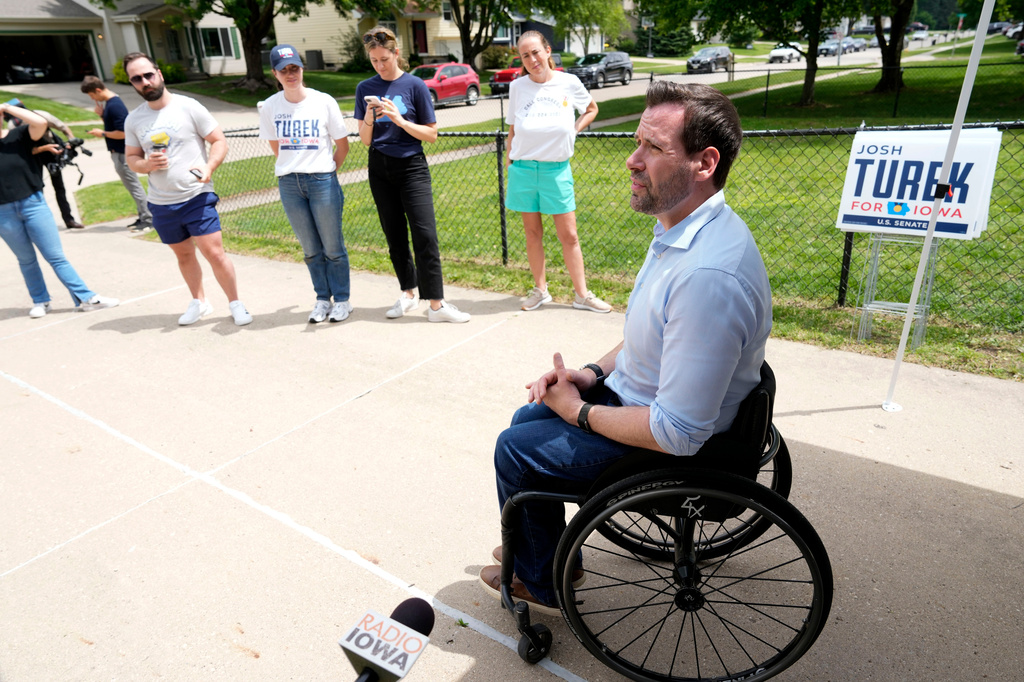 FILE - Iowa state Rep. Josh Turek, a Democratic candidate for U.S. Senate, talks to supporters before a neighborhood canvassing event, May 31, 2026, in Waukee, Iowa. (AP Photo/Charlie Neibergall, File)