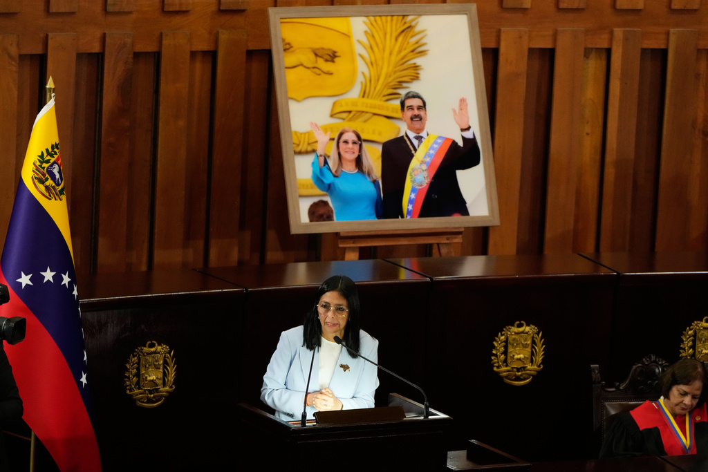 Venezuelan acting President Delcy Rodriguez speaks under a framed image of former President Nicolas Maduro and his wife Cilia Flores, during a ceremony marking the opening of the new judicial year at the Supreme Tribunal of Justice in Caracas, Venezuela, Friday, Jan. 30, 2026. (AP Photo/Ariana Cubillos)