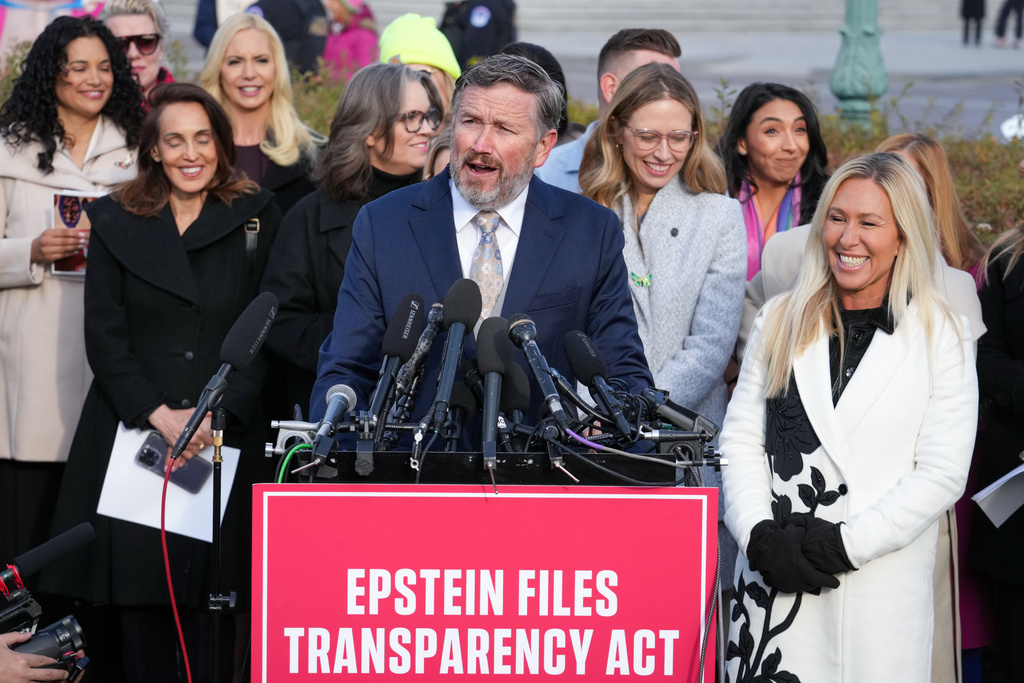 Rep. Thomas Massie, R-Ky., and Rep. Marjorie Taylor-Greene, R-Ga., right, speak during a news conference as the House prepares to vote on the Epstein Files Transparency Act, at the Capitol in Washington, Tuesday, Nov. 18, 2025. They are joined by survivors and family members who recounted their personal stories of Epstein. (AP Photo/J. Scott Applewhite)
