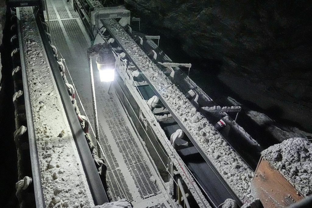 The finished product, de-icing solution - rock salt - approximately 11,000 - 14,000 tons per day, is transported by conveyor belt to a skip which will take it to the surface at the Cargill salt mine on Whiskey Island in Cleveland, Ohio, Thursday, March 19, 2026. (AP Photo/Sue Ogrocki)