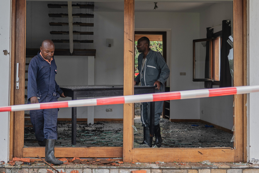 People clear a house hit by a drone strike in Goma, Democratic Republic of Congo, Wednesday, March 11, 2026. (AP Photo/Moses Sawasawa)