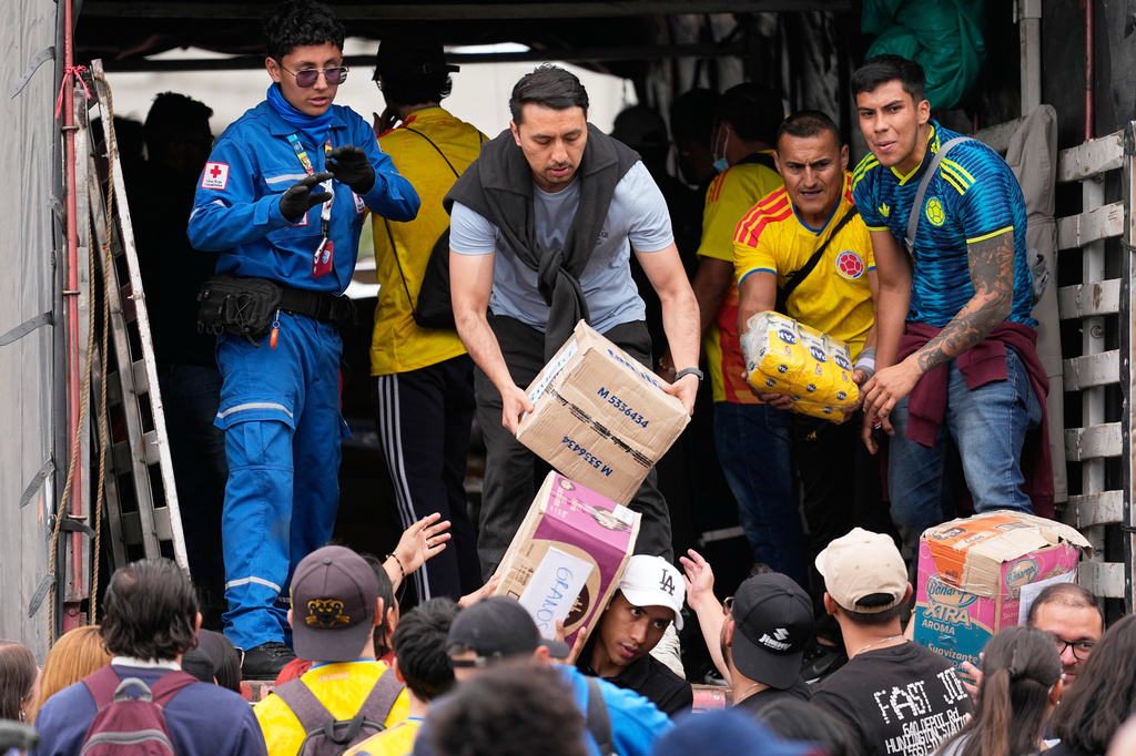 Volunteers in Bogota, Colombia, sort aid for people affected by the earthquake, Thursday, Aug. 13, 2026. (AP Photo/Fernando Vergara)