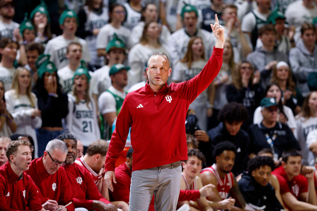 Indiana coach Darian Devries signals during the first half of an NCAA college basketball game, Tuesday, Jan. 13, 2026, in East Lansing, Mich. (AP Photo/Al Goldis)