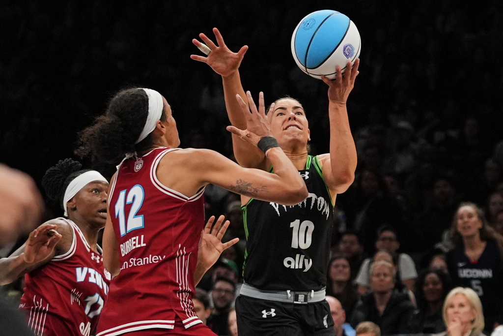 Vinyl BC wing Rae Burrell (12) defends Phantom BC guard Kelsey Plum (10) during the second half of a semifinal in their Unrivaled 3-on-3 basketball game, Monday, March 2, 2026, in New York. (AP Photo/Frank Franklin II)