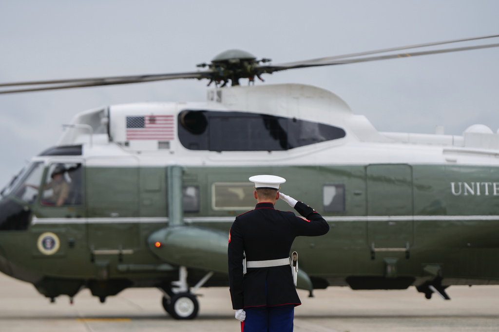 A Marine salutes as Marine One carrying President Donald Trump lands at Joint Base Andrews, Md., Sunday, Sept. 21, 2025. (AP Photo/Julia Demaree Nikhinson)