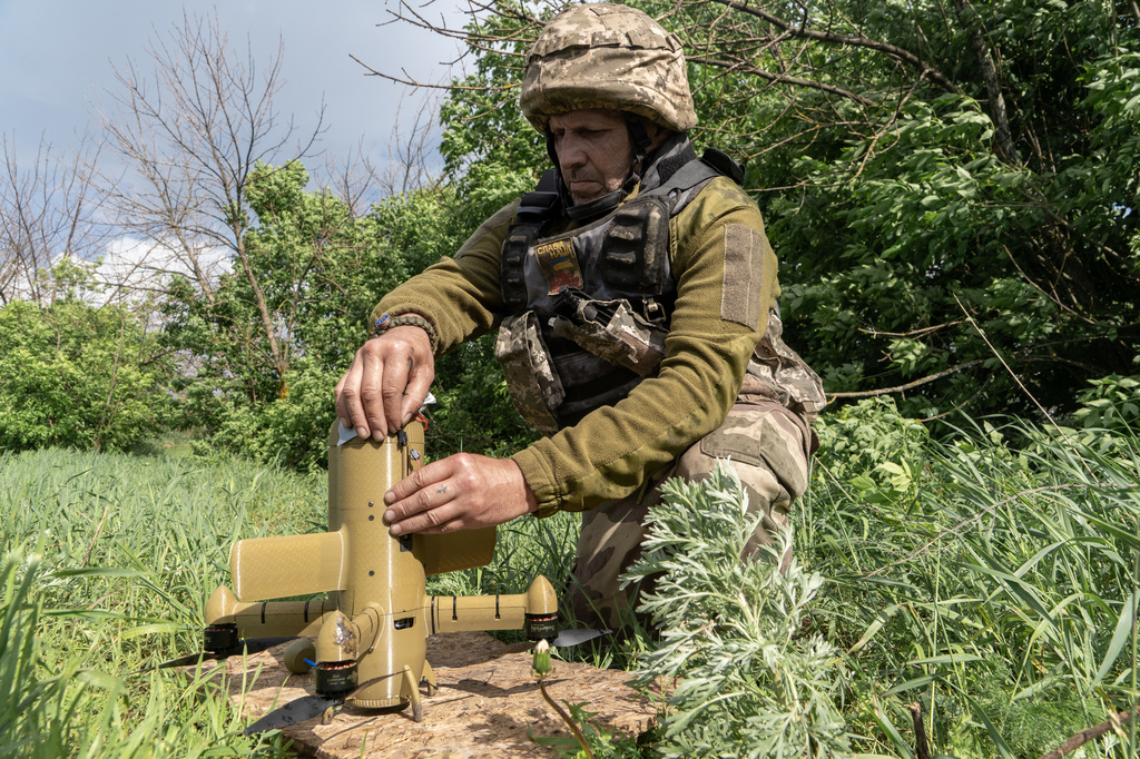 A Ukrainian soldier prepares an interceptor drone during a Russia's aerial attack at an undisclosed location near Kharkiv, Ukraine, Monday, May 25, 2026. (AP Photo/Andrii Marienko)