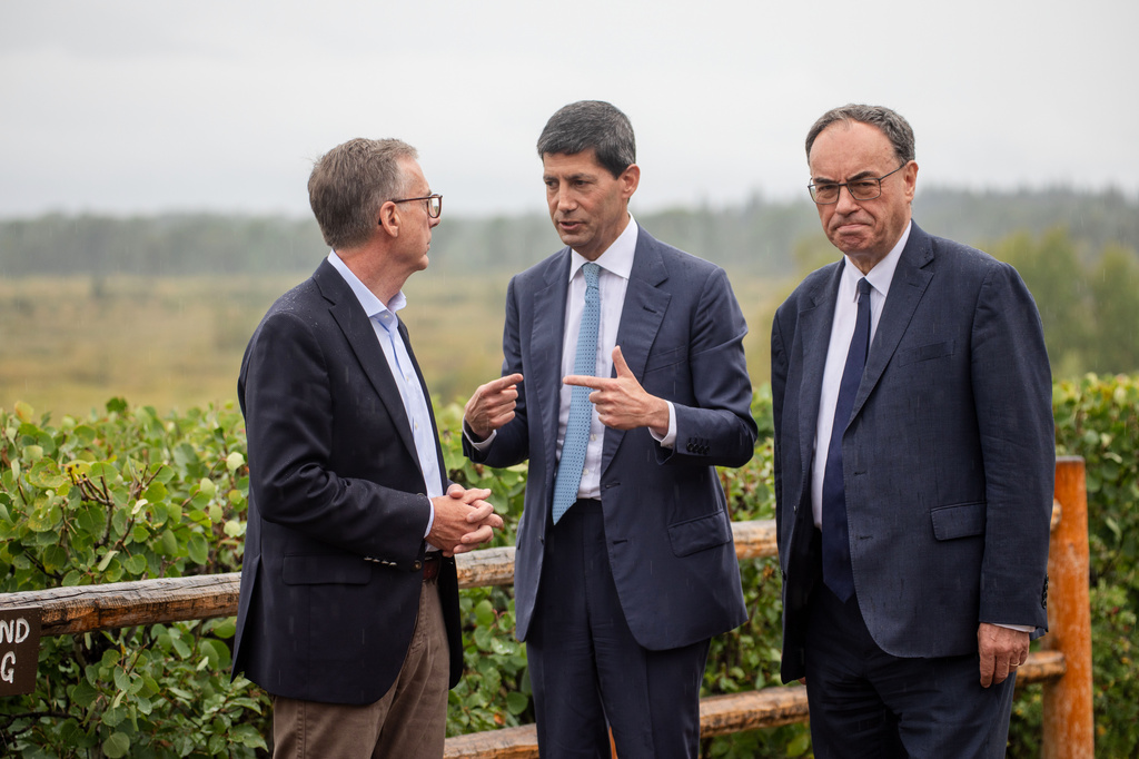 Fed Chair Kevin Warsh, center, talks to Bank of England Governor Andrew Bailey, right, and Bank of Canada Governor Tiff Macklem at the annual Jackson Hole Economic Policy Symposium on Friday, Aug. 28, 2026, in Moran, Wyo. (AP Photo/Amber Baesler)