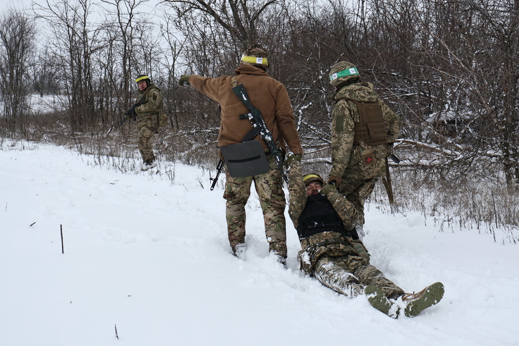 In this photo provided by Ukraine's 65th Mechanized Brigade press service, recruits attend drills at a training ground in the Zaporizhzhia region, Ukraine, Monday, Dec. 29, 2025. (Andriy Andriyenko/Ukraine's 65th Mechanized Brigade via AP)