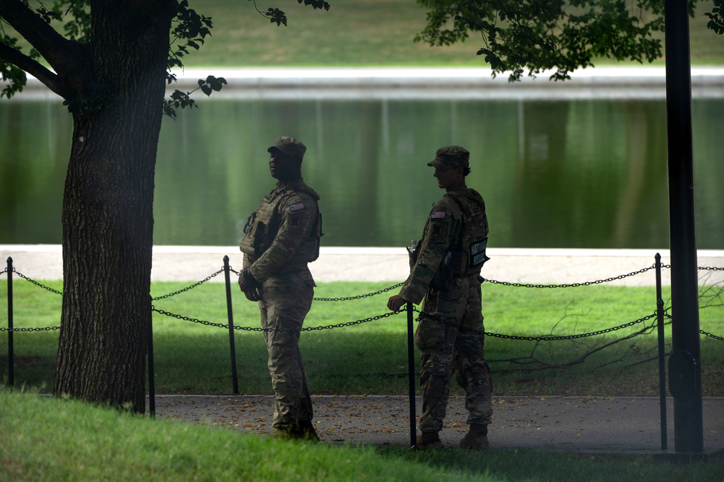 National Guard members stand near the Lincoln Memorial Reflecting Pool, Friday, July 10, 2026, in Washington. (AP Photo/Mark Schiefelbein)
