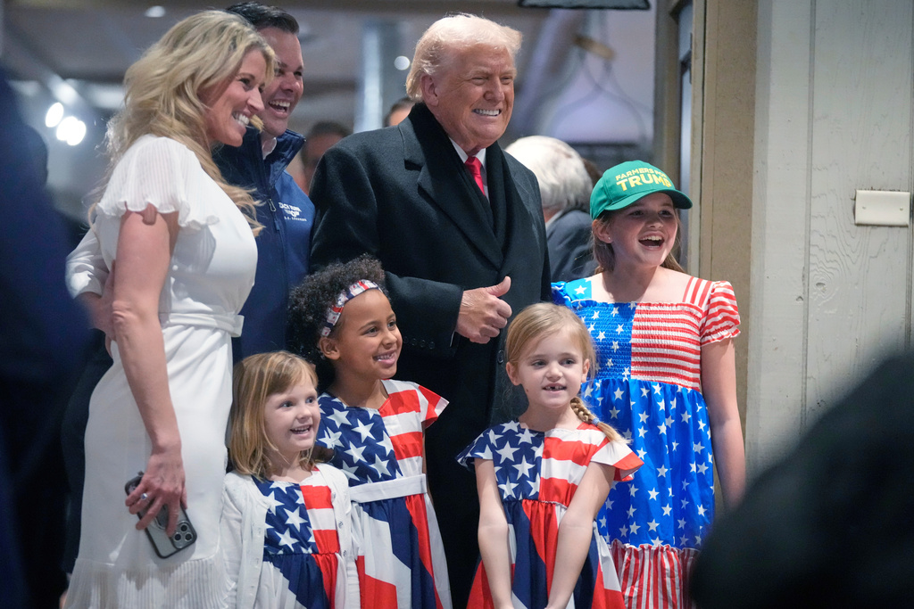 President Donald Trump smiles as he poses for pictures during a visit to a restaurant in Urbandale, Iowa, Tuesday, Jan. 27, 2026. (AP Photo/Mark Schiefelbein)