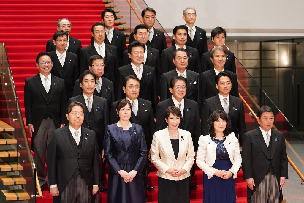 Japan's Prime Minister Sanae Takaichi, front center, and her new cabinet members pose for a group photo Wednesday, Feb. 18, 2026, in Tokyo. (Kazuhiro Nogi/Pool Photo via AP)