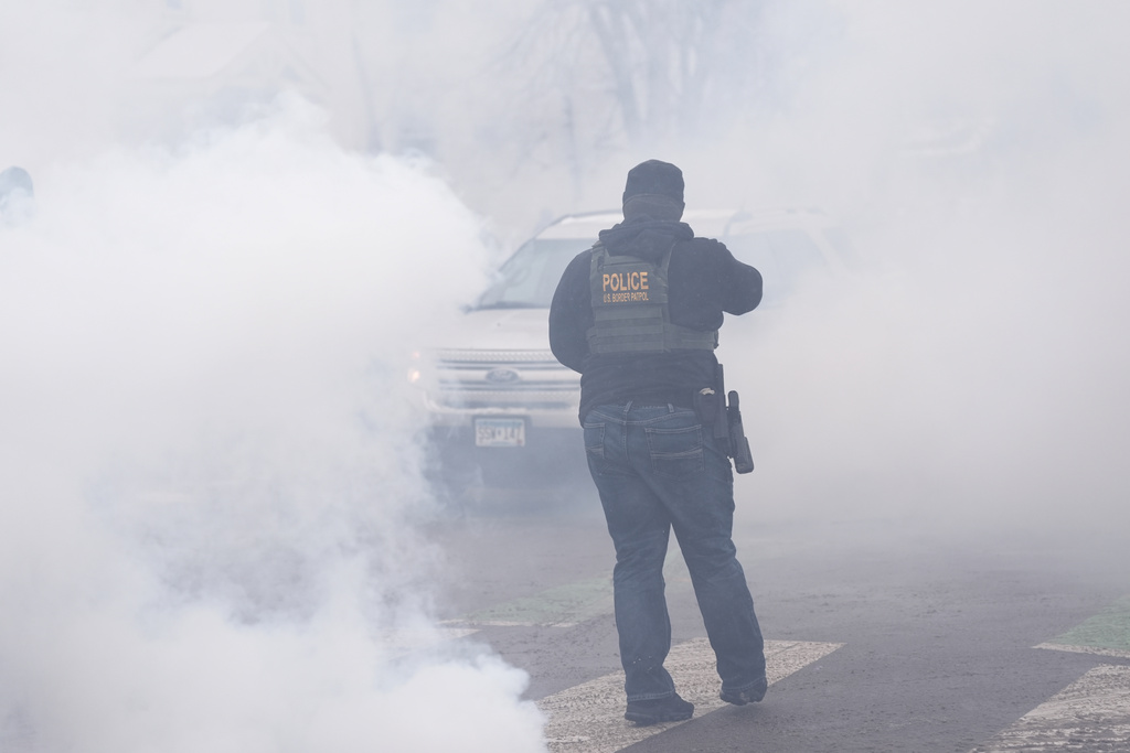 Tear gas is deployed as Federal agents make arrests on Wednesday, Jan. 21, 2026, in Minneapolis. (AP Photo/Angelina Katsanis)