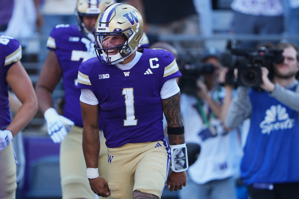 Washington quarterback Demond Williams Jr. celebrates scoring a touchdown against Washington State during the first half of an NCAA college football game, Sunday, Sept. 6, 2026, in Seattle. (AP Photo/Lindsey Wasson)