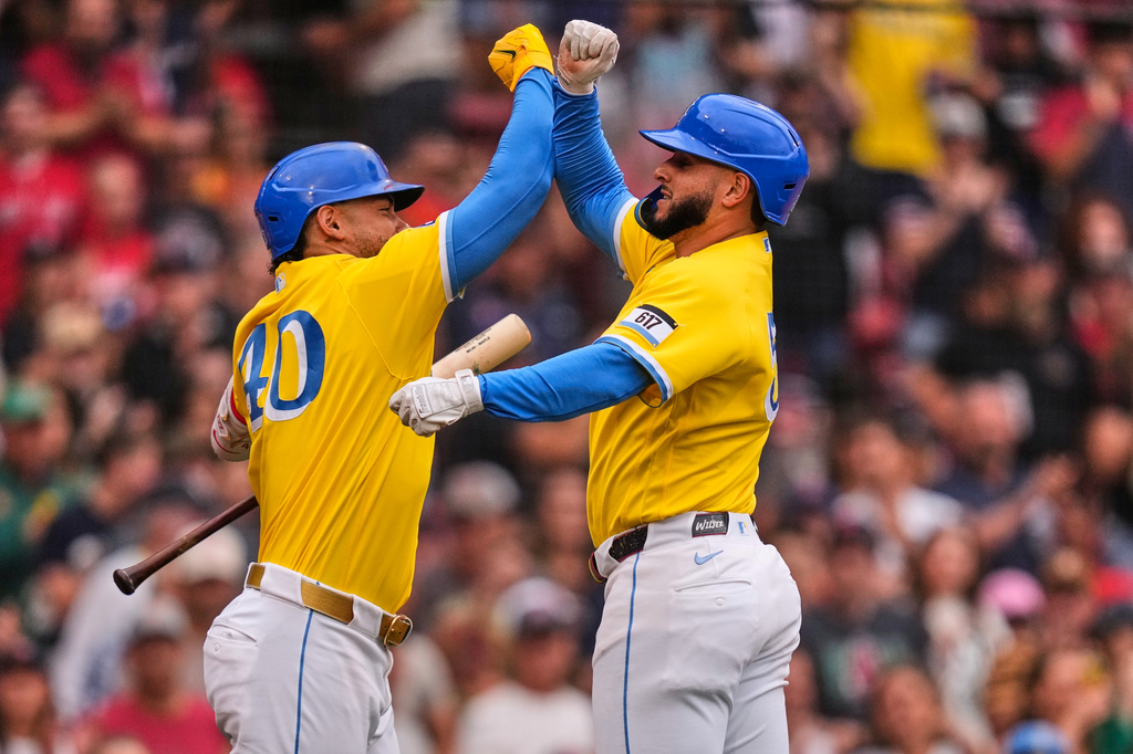 Boston Red Sox's Wilyer Abreu, right, is congratulated by Willson Contreras after hitting a solo home run in the third inning of a baseball game against the Tampa Bay Rays, Saturday, July 18, 2026, in Boston. (AP Photo/Charles Krupa)