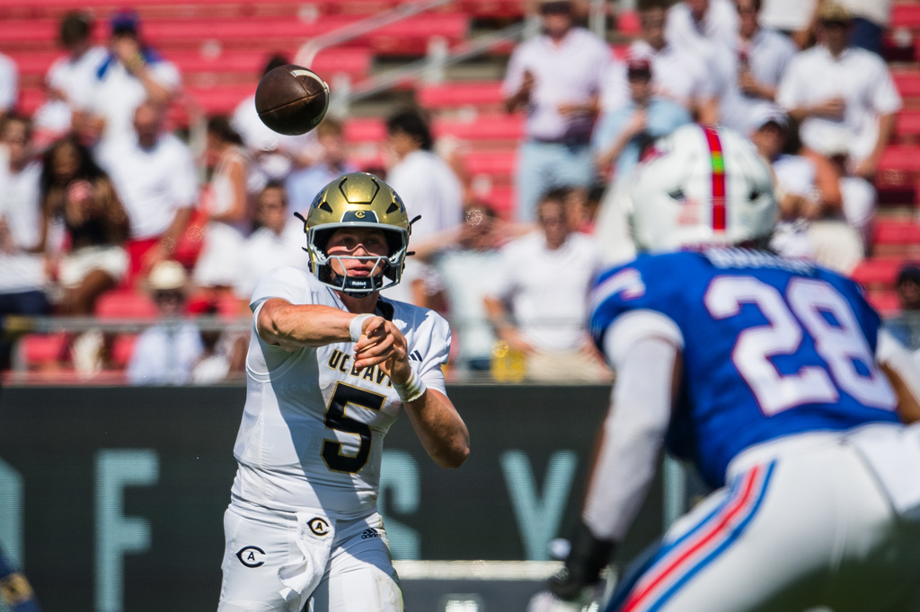 UC Davis' quarterback Treynor Cleeland (5) throws the ball during a football game against SMU in Dallas, Saturday, Sept. 12, 2026. (AP Photo/Jessica Tobias)