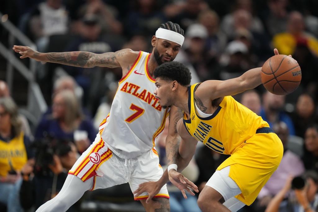 Indiana Pacers' Rayj Dennis (10) is defended by Atlanta Hawks' Nickeil Alexander-Walker (7) during the second half of an NBA Cup basketball game, Friday, Oct. 31, 2025, in Indianapolis. (AP Photo/Darron Cummings)