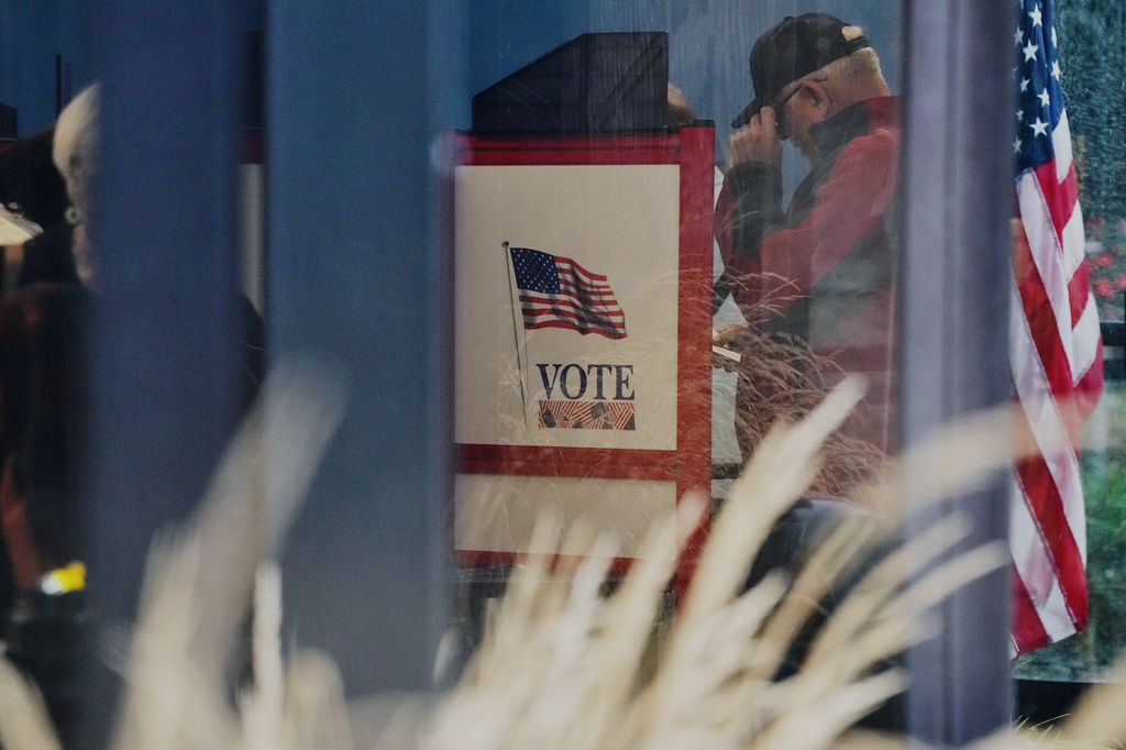 A voter casts a ballot on the first day of early voting in Minnesota at the Elections & Voter Services building, Friday, Sept. 18, 2026, in Minneapolis. (AP Photo/Ellen Schmidt)