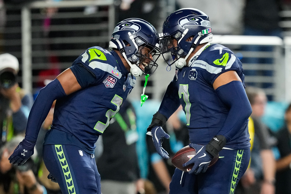 Seattle Seahawks linebacker Uchenna Nwosu (7) celebrates his touchdown on a fumble recovery with safety Nick Emmanwori (3) during the second half of the NFL Super Bowl 60 football game against the New England Patriots, Sunday, Feb. 8, 2026, in Santa Clara, Calif. (AP Photo/Julio Cortez)