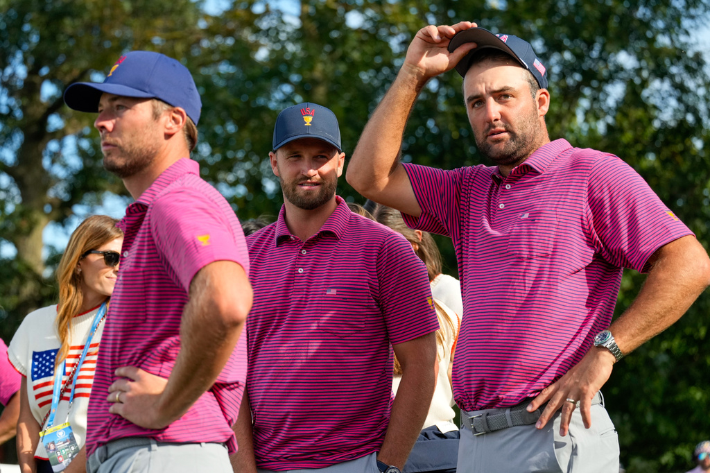 From left: USA teams' Sam Burns, Wyndham Clark and Scottie Scheffler watch plays on the 16th hole against the International team during a Presidents Cup golf tournament final round singles match at Medinah Country Club, Sunday, Sept. 27, 2026, in Medinah, Ill. (AP Photo/Chris Carlson)
