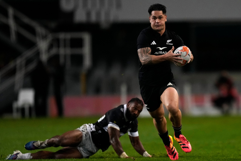 All Blacks' Quinn Tupaea, right, breaks away from Sharks' Jurenzo Julius during a friendly rugby match between Sharks and All Blacks, in Durban, South Africa, Tuesday, Aug. 11, 2026. (AP Photo/Themba Hadebe)