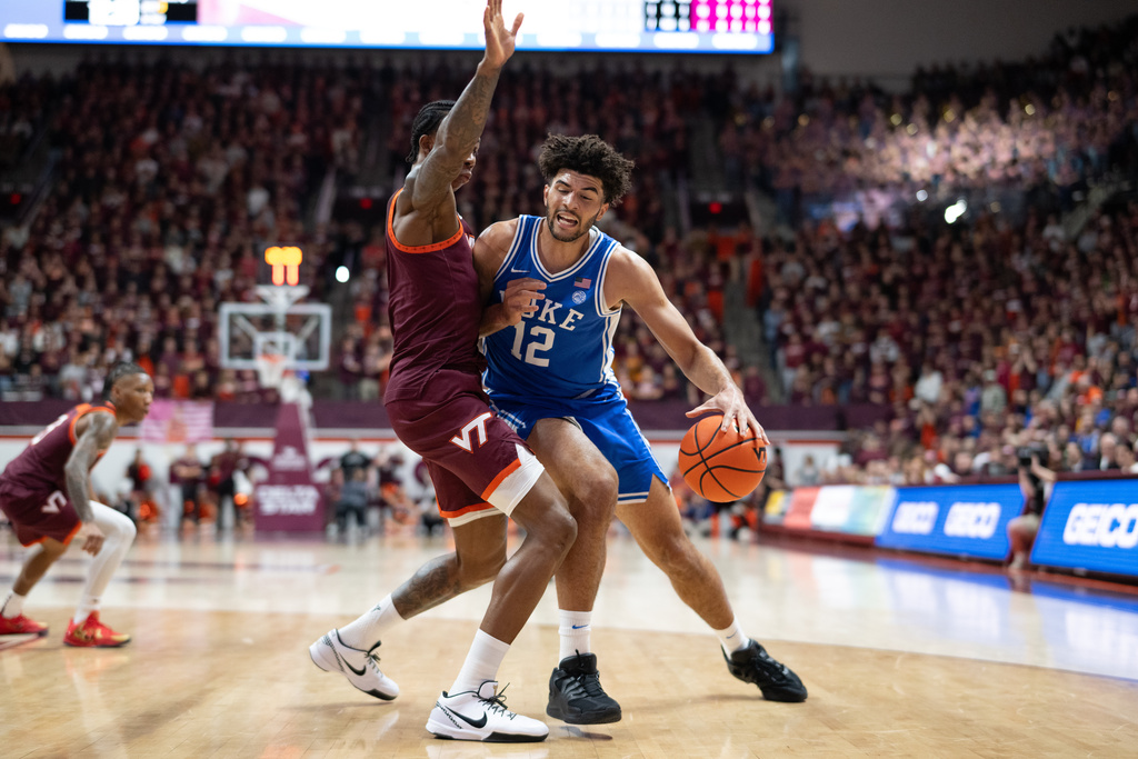 Duke forward Cameron Boozer (12) is stoppped by Virginia Tech forward Tobi Lawal (1) during the first half of an NCAA college basketball game, Saturday, Jan. 31, 2026, in Blacksburg, Va. (AP Photo/Robert Simmons)