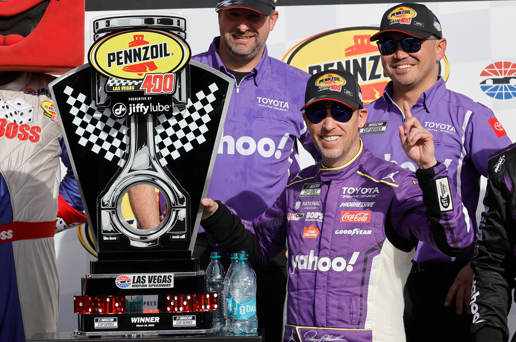 Denny Hamlin poses with his trophy in Victory Lane after winning a NASCAR Cup Series auto race at, Sunday, March 15, 2026, in Las Vegas. (AP Photo/Steve Marcus)