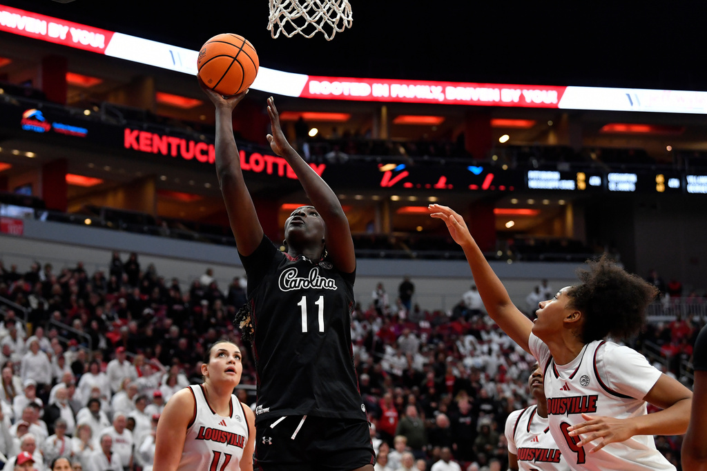 South Carolina center Madina Okot (11) shoots over Louisville forward Anaya Hardy (9) during the second half of an NCAA college basketball game in Louisville, Ky., Thursday, Dec. 4, 2025. (AP Photo/Timothy D. Easley)