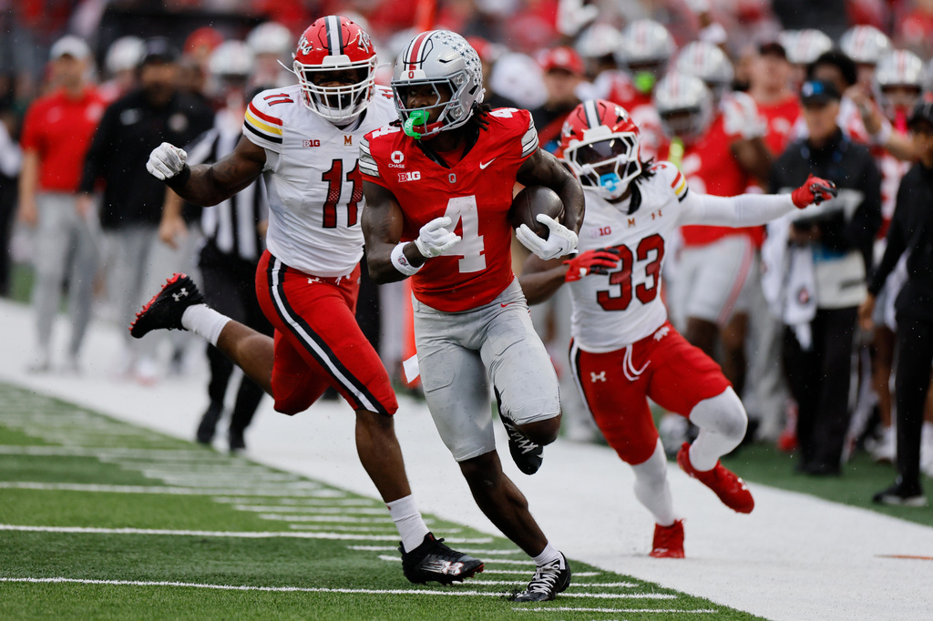 Ohio State wide receiver Jeremiah Smith, center, runs to score a touchdown against Maryland during the first half of an NCAA college football game, Saturday, Oct. 10, 2026, in Columbus, Ohio. (AP Photo/Jay LaPrete)