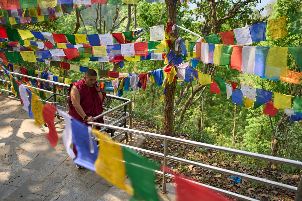 Jalue Dorje speaks on the phone during a visit to Maratika Caves, in eastern Nepal, Monday, April 13, 2026. (AP Photo/Niranjan Shrestha)