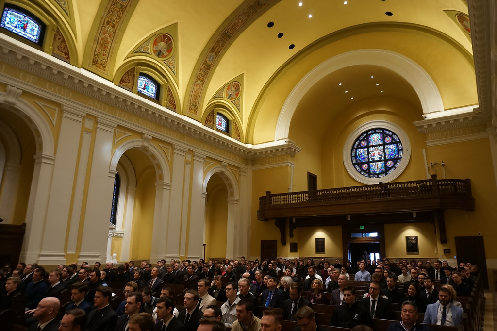 Seminarians, members of the University of St. Thomas and school principals participate in a Mass in solidarity with migrants celebrated by three Catholic cardinals and the Twin Cities' archbishop at the Chapel of St. Thomas Aquinas in St. Paul, Minn., on Friday, Feb. 27, 2026 (AP Photo/Giovanna Dell'Orto)