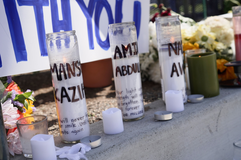 FILE - Candles with victim's names written on them are placed outside the Islamic Center of San Diego, in the aftermath of a shooting, on May 20, 2026, in San Diego. (AP Photo/Ty ONeil, File)