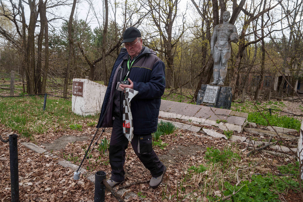 A man measures radiation near the site of the Chernobyl nuclear power plant, Tuesday, April 21, 2026, in Chernobyl, Ukraine. (AP Photo/Evgeniy Maloletka)
