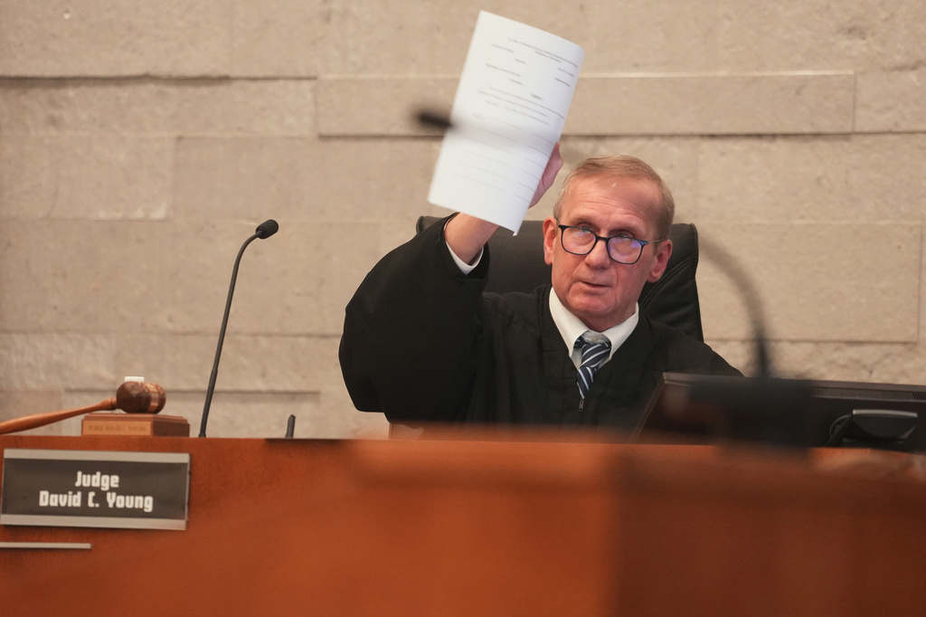 Judge David Young holds up jury instructions during closing arguments in former sheriff's deputy Jason Meade's retrial in Franklin County Court of Common Pleas on Wednesday, May 6, 2026, in Columbus, Ohio. (Doral Chenoweth/The Columbus Dispatch via AP, Pool)