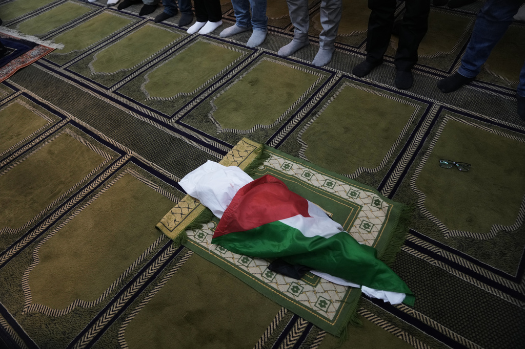 Mourners pray over the body of seven month old Palestinian baby boy Sam Fahd Abu Haikal, who was killed on Friday when, according to the Palestinian health ministry, Israeli soldiers fired at the vehicle carrying him and his parents in Tel Rumeida, during his funeral in the West Bank city of Hebron, Saturday, June 6, 2026. (AP Photo/Mahmoud Illean)