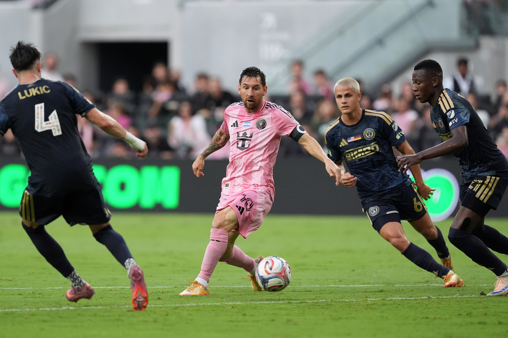 Inter Miami forward Lionel Messi (10) comes under pressure from Philadelphia Union midfielder Jovan Lukic (4), midfielder Cavan Sullivan (6), and midfielder Danley Jean Jacques (21), during the first half of an MLS soccer match, Sunday, May 24, 2026, in Miami. (AP Photo/Rebecca Blackwell)
