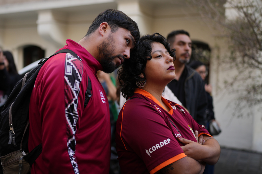 Supporters react to early results at the campaign headquarters of Jeannette Jara, presidential candidate of the ruling Unity for Chile coalition, in Santiago, Chile, Sunday, Dec. 14, 2025. (AP Photo/Natacha Pisarenko)