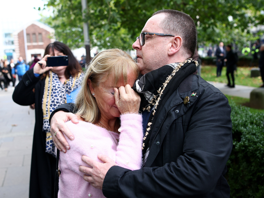 Caroline O'Donnell, left, is comforted outside Belfast Crown Court following the not guilty verdict of the British soldier known as Soldier F in the 1972 Bloody Sunday Massacre Belfast, Northern Ireland, Thursday, Oct. 23, 2025. (AP Photo/Peter Morrison)