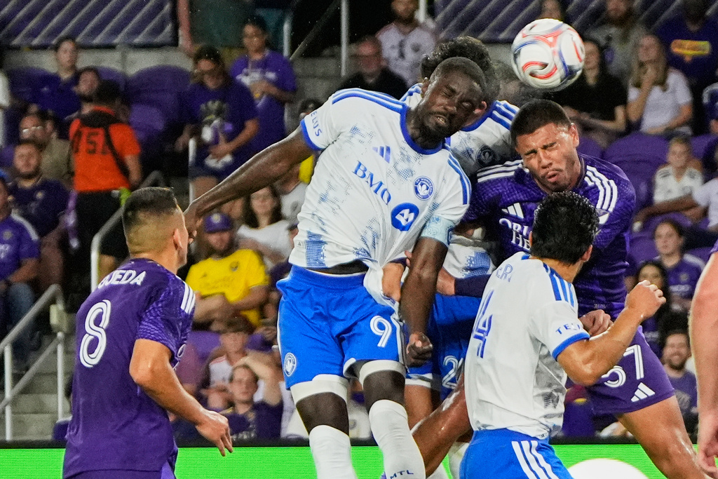 CF Montreal forward Prince Owusu (9) heads the ball to score a goal off a corner kick against Orlando City defender Iago during the first half of an MLS soccer match, Saturday, March 14, 2026, in Orlando, Fla. (AP Photo/John Raoux)