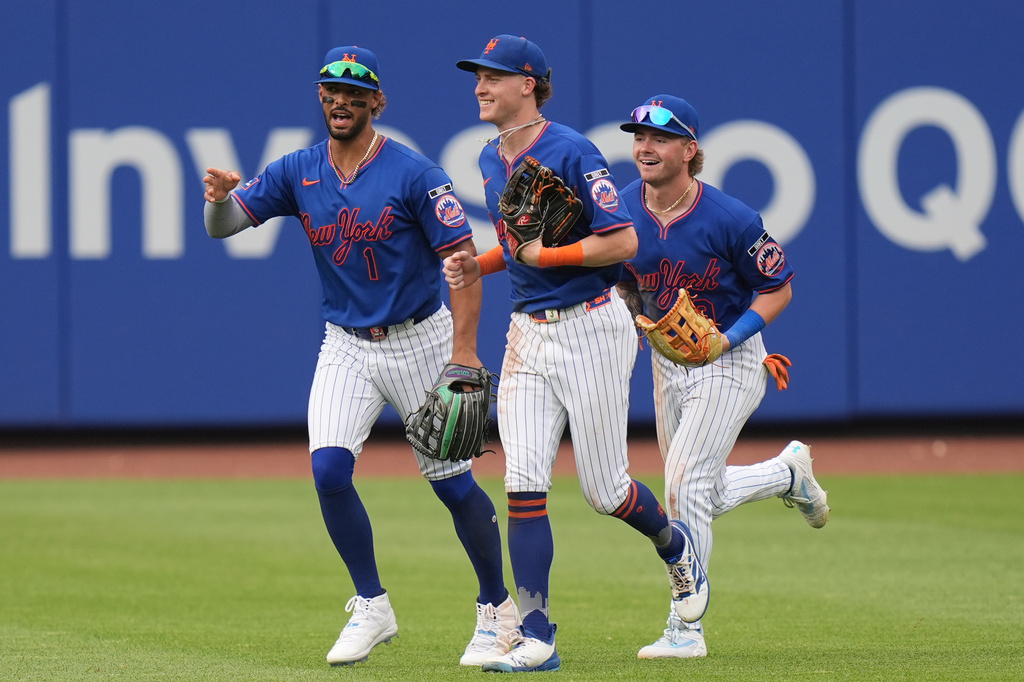 New York Mets outfielders Mj Melendez, left, Carson Benge, center, and A.J. Ewing celebrate after a baseball game against the Atlanta Braves, Sunday, June 14, 2026, in New York. (AP Photo/Seth Wenig)